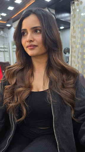 Client with soft caramel balayage waves at Rewind Looks Salon