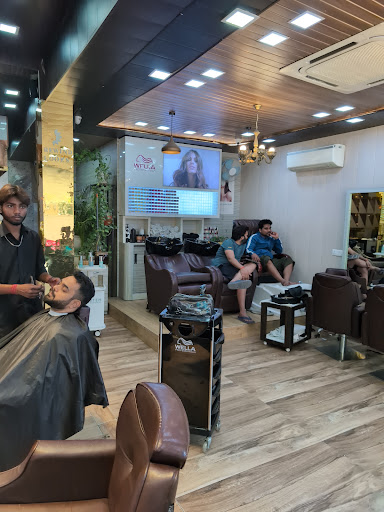 Beard trim in progress, lounge behind